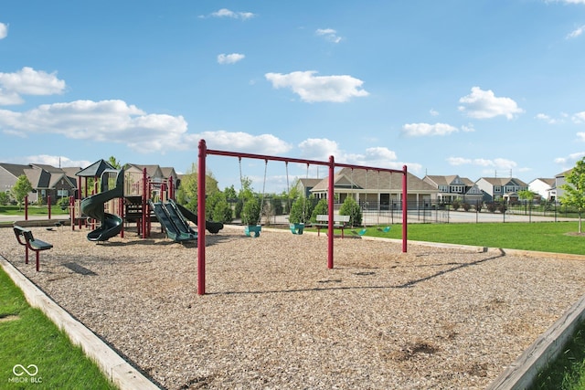 community jungle gym featuring fence and a residential view