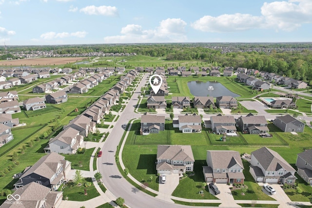 aerial view of property's location with a large body of water and nearby suburban area