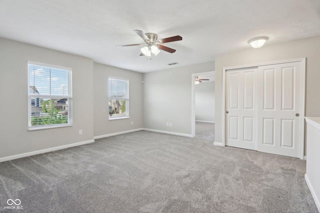 unfurnished bedroom with carpet floors, a closet, and baseboards