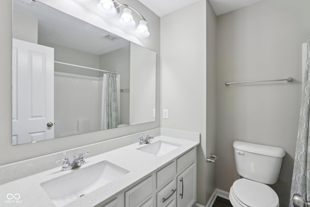 bathroom with toilet, double vanity, and a shower with shower curtain