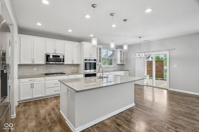 kitchen with appliances with stainless steel finishes, a sink, tasteful backsplash, plenty of natural light, and recessed lighting