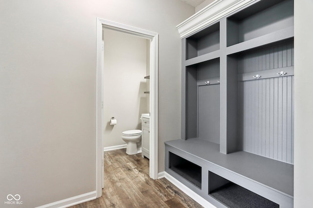 mudroom with wood finished floors and baseboards