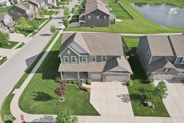 aerial view of residential area featuring a large body of water