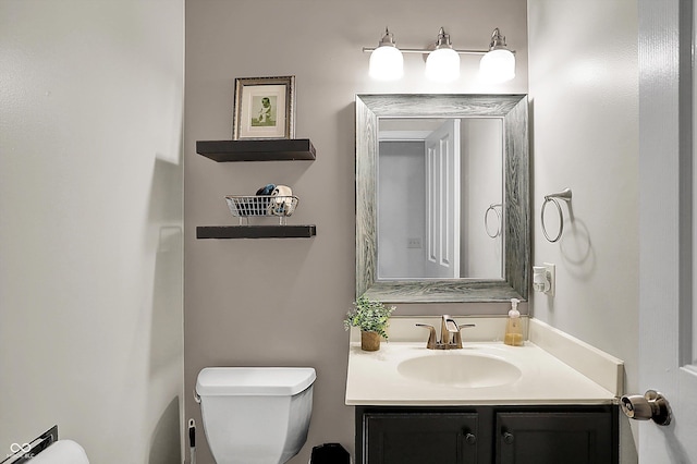 half bath featuring toilet and vanity