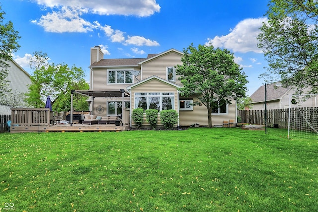 rear view of house featuring a wooden deck, outdoor lounge area, a fenced backyard, a chimney, and a lawn