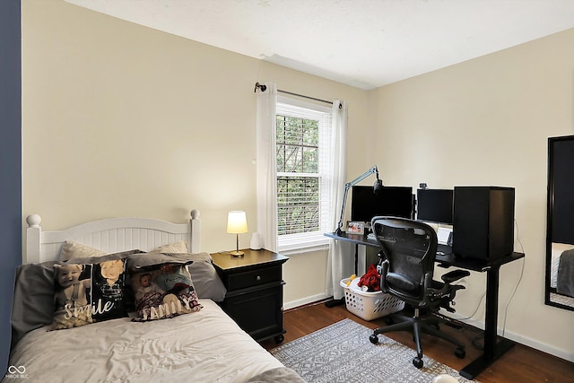 bedroom featuring baseboards and wood finished floors