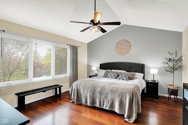 bedroom featuring a ceiling fan, baseboards, lofted ceiling, and hardwood / wood-style floors