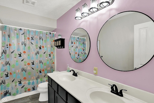 bathroom with visible vents, a sink, a textured ceiling, and toilet