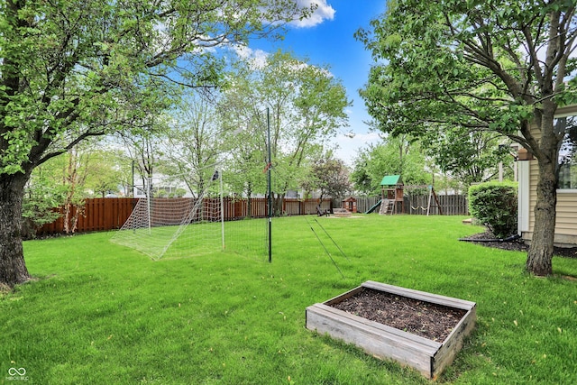 view of yard with fence and a playground