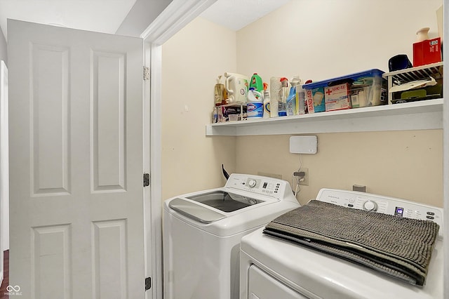 laundry area featuring washing machine and clothes dryer and laundry area