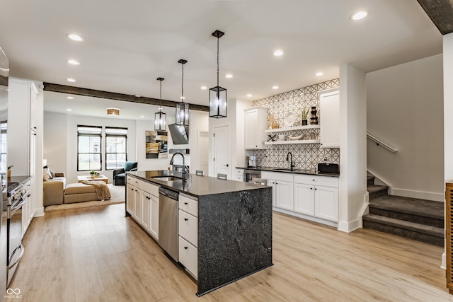 1534 Fletcher Ave, Indianapolis, IN 46203 - kitchen featuring dark countertops, stainless steel appliances, open floor plan, light wood-style floors, and recessed lighting
