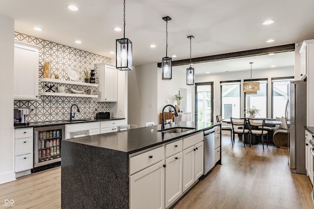 1534 Fletcher Ave, Indianapolis, IN 46203 - kitchen with wine cooler, stainless steel appliances, light wood-type flooring, recessed lighting, and backsplash