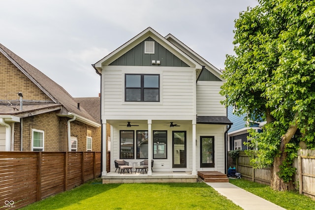 1534 Fletcher Ave, Indianapolis, IN 46203 - back of property with ceiling fan, board and batten siding, and a fenced backyard