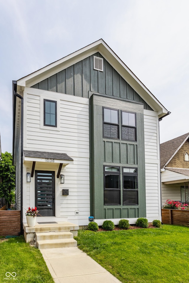 1534 Fletcher Ave, Indianapolis, IN 46203 - view of front of home with board and batten siding and a front lawn