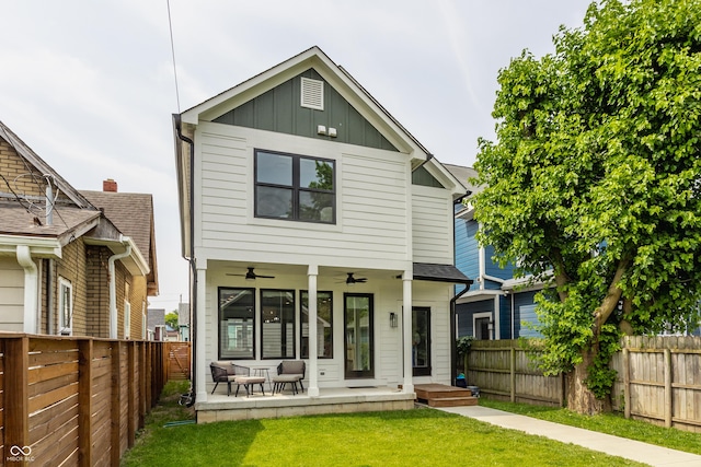 1534 Fletcher Ave, Indianapolis, IN 46203 - back of house featuring a ceiling fan, a fenced backyard, and board and batten siding