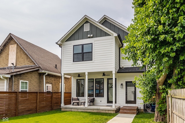 1534 Fletcher Ave, Indianapolis, IN 46203 - rear view of house featuring a ceiling fan, board and batten siding, a fenced backyard, and a shingled roof
