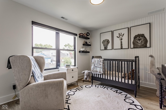 1534 Fletcher Ave, Indianapolis, IN 46203 - bedroom featuring wood finished floors and wallpapered walls