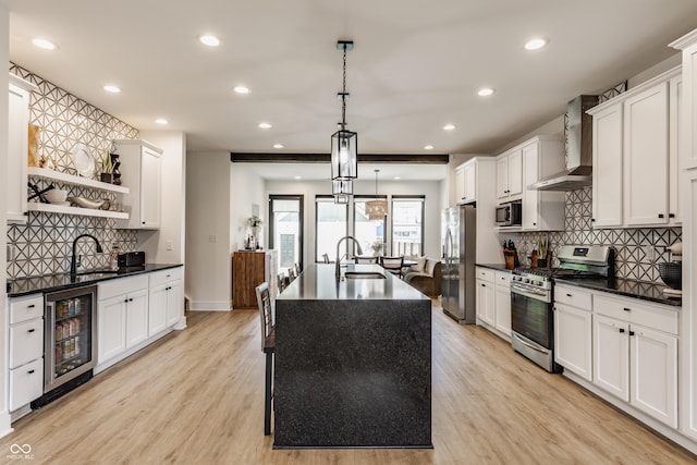 1534 Fletcher Ave, Indianapolis, IN 46203 - kitchen featuring appliances with stainless steel finishes, wall chimney range hood, beverage cooler, open shelves, and dark countertops