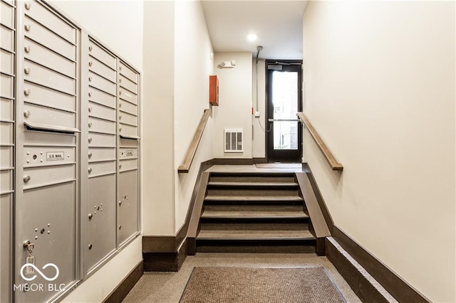 622 E 10th St Unit 212, Indianapolis, IN 46202 - stairway with baseboards, mail area, and visible vents