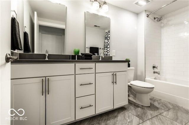 622 E 10th St Unit 212, Indianapolis, IN 46202 - full bath with visible vents, double vanity, marble finish floor, toilet, and a sink