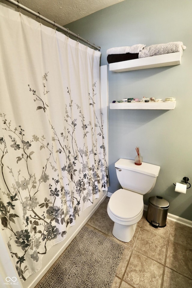 10688 Ashview Dr, Fishers, IN 46038 - full bathroom featuring toilet, baseboards, tile patterned flooring, and a textured ceiling