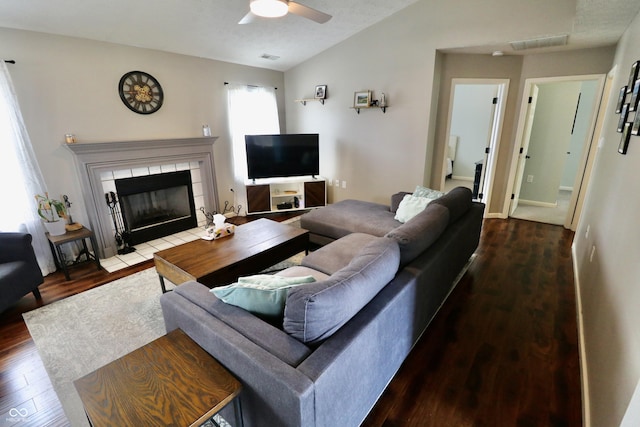 10688 Ashview Dr, Fishers, IN 46038 - living area with visible vents, wood finished floors, ceiling fan, a tiled fireplace, and vaulted ceiling