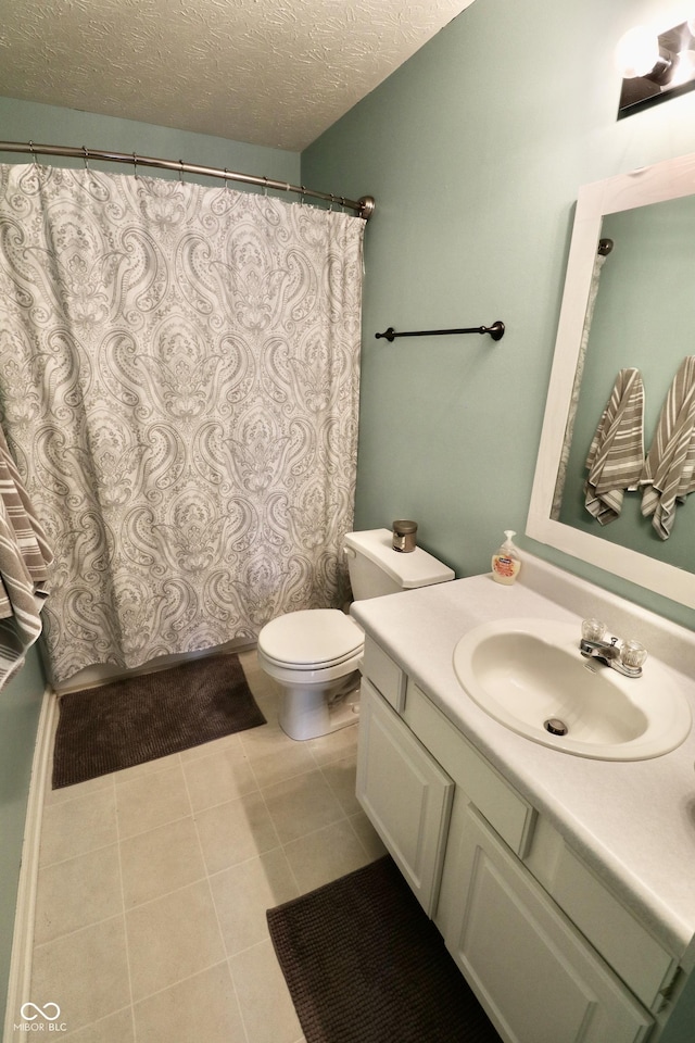 10688 Ashview Dr, Fishers, IN 46038 - full bath with tile patterned flooring, vanity, toilet, a textured ceiling, and a shower with shower curtain