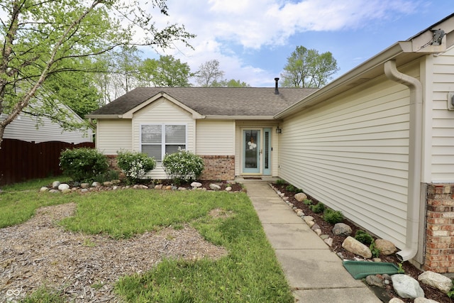 10688 Ashview Dr, Fishers, IN 46038 - property entrance featuring a yard, brick siding, fence, and roof with shingles