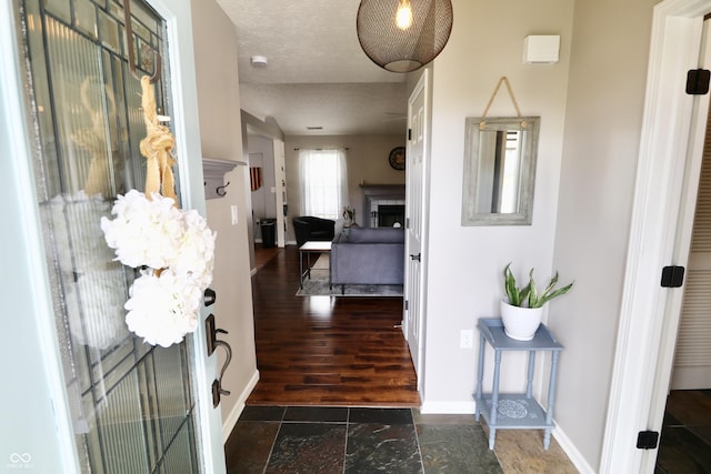 10688 Ashview Dr, Fishers, IN 46038 - foyer with stone tile floors, baseboards, and a fireplace