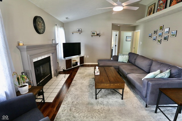 10688 Ashview Dr, Fishers, IN 46038 - living room featuring ceiling fan, wood finished floors, vaulted ceiling, and a fireplace