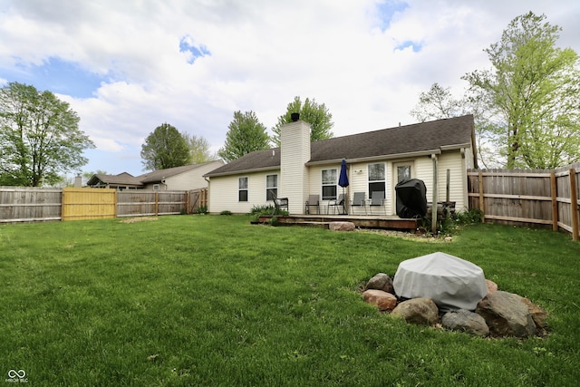 10688 Ashview Dr, Fishers, IN 46038 - back of property with a fenced backyard, a yard, and a chimney