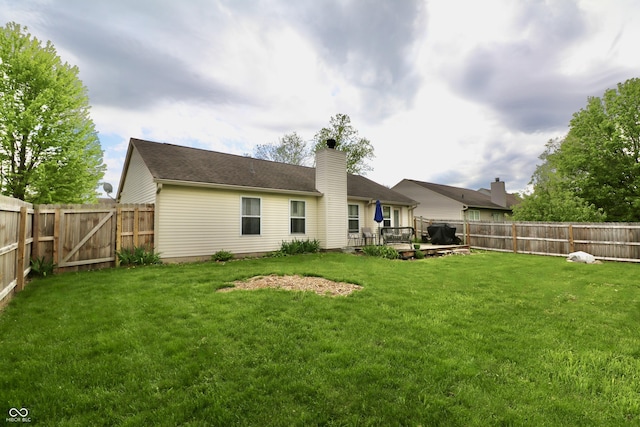 10688 Ashview Dr, Fishers, IN 46038 - rear view of house featuring a lawn, a gate, a chimney, and a fenced backyard