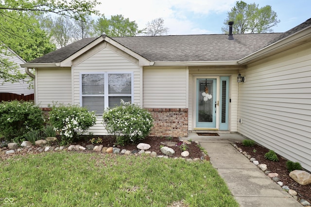 10688 Ashview Dr, Fishers, IN 46038 - doorway to property featuring a lawn, brick siding, and a shingled roof