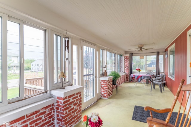 sunroom featuring carpet floors, wood ceiling, and a wealth of natural light