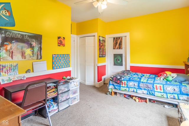 bedroom with ceiling fan, carpet, and a closet