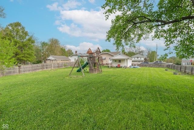 view of yard with a playground and a fenced backyard