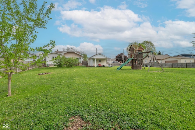 view of yard featuring fence and a playground