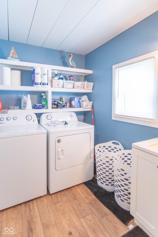 laundry room with laundry area, light wood-style flooring, and washing machine and dryer