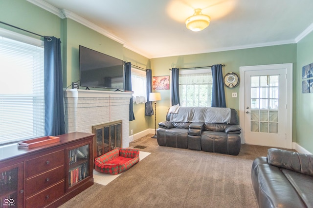 living area with carpet floors, crown molding, visible vents, a fireplace, and baseboards