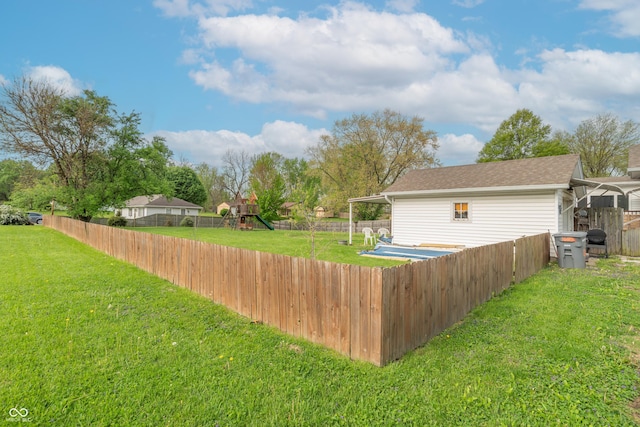 view of yard featuring a playground and a fenced backyard
