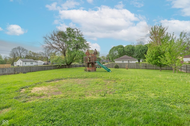 view of yard with a fenced backyard and a playground