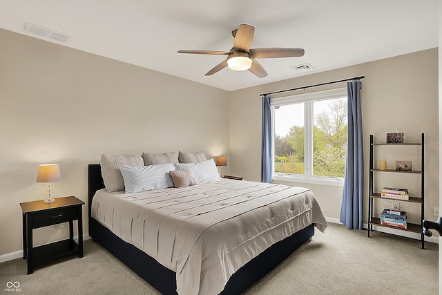 bedroom with baseboards, visible vents, light carpet, and ceiling fan