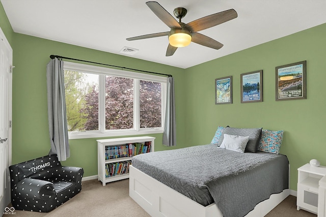 carpeted bedroom featuring baseboards, ceiling fan, and visible vents