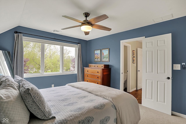 bedroom featuring baseboards, carpet, vaulted ceiling, and visible vents
