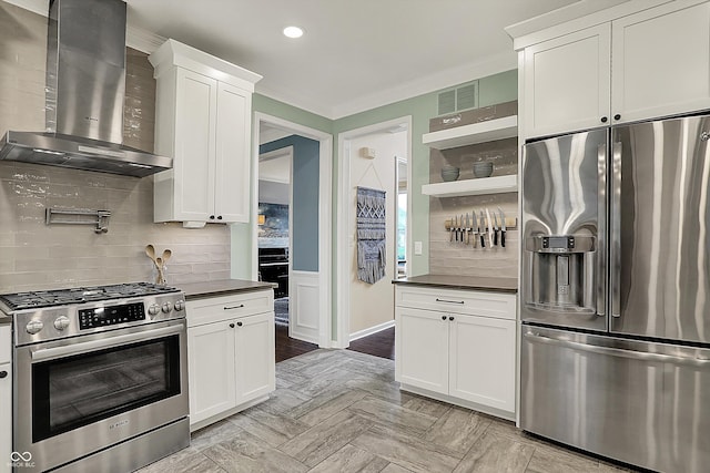 kitchen with visible vents, dark countertops, appliances with stainless steel finishes, open shelves, and wall chimney exhaust hood