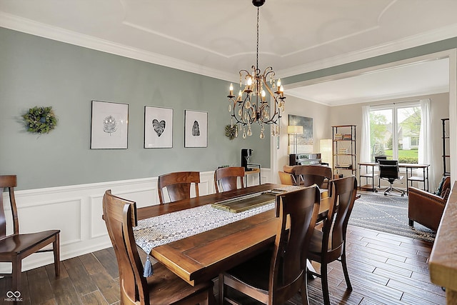 dining area with ornamental molding, dark wood-style flooring, wainscoting, and a chandelier