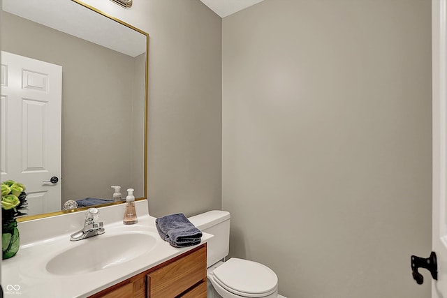 half bath with vanity and toilet