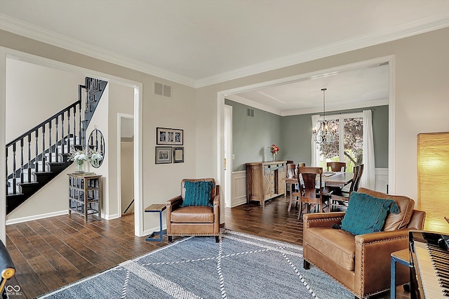 living area with ornamental molding, stairs, wood finished floors, and visible vents
