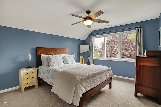carpeted bedroom with baseboards, visible vents, ceiling fan, and vaulted ceiling