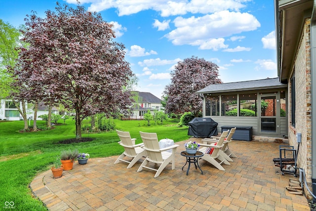 view of patio / terrace featuring a sunroom and grilling area